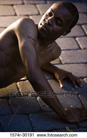 View of a young man lying on the tiled floor View Large Photo Image Stock Image - View of a young man lying on the tiled floor. Fotosearch