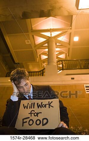 Well-dressed jobless man holding a placard View Large Photo Image Stock Photo - Well-dressed jobless man holding a placard. Fotosearch