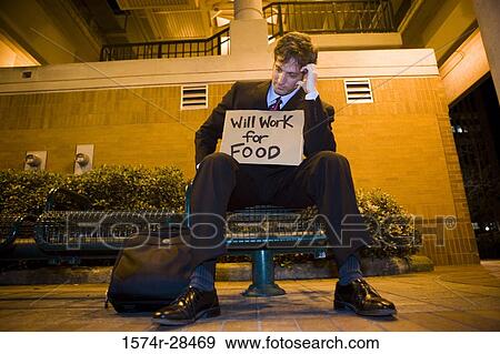 Well-dressed man sitting on bench with a placard and briefcase View Large Photo Image Stock Photo - Well-dressed man sitting on bench with a placard and briefcase. Fotosearch