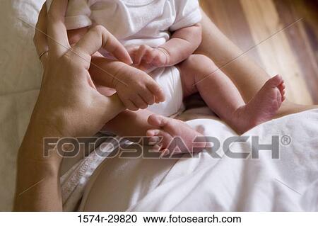 Woman holding her baby View Large Photo Image Stock Image - Woman holding her baby. Fotosearch