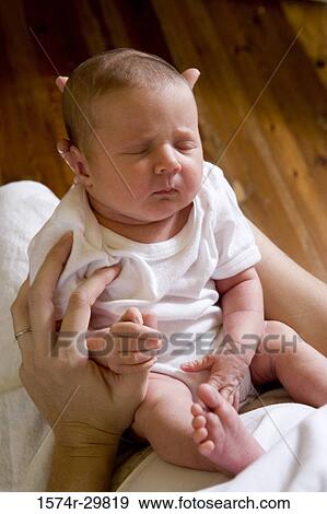 Woman holding her baby View Large Photo Image Stock Photo - Woman holding her baby. Fotosearch