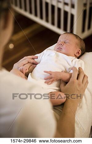 Woman holding her baby's legs View Large Photo Image Stock Photograph - Woman holding her baby's legs. Fotosearch