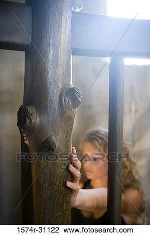 Wooden log by railing with a young woman standing in the background View Large Photo Image Stock Image - Wooden log by railing with a young woman standing in the background. Fotosearch