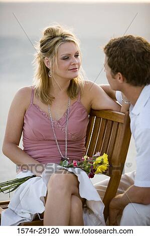 Young couple looking at each other at the beach View Large Photo Image Stock Image - Young couple looking at each other at the beach. Fotosearch