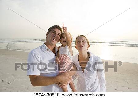 Young couple with daughter at beach View Large Photo Image Stock Photo - Young couple with daughter at beach. Fotosearch