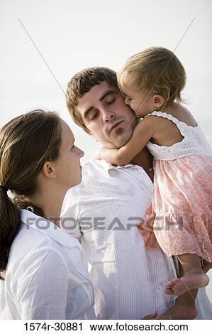 Young couple with daughter on the beach View Large Photo Image Stock Image - Young couple with daughter on the beach. Fotosearch