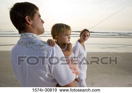 Young couple with daughter on the beach View Large Photo Image Stock Photo - Young couple with daughter on the beach. Fotosearch