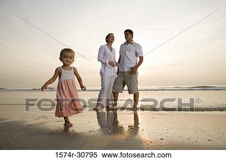 Young couple with daughter relaxing on the beach View Large Photo Image Stock Photography - Young couple with daughter relaxing on the beach. Fotosearch