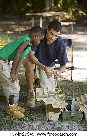 Young man and a boy by a fishing tackle box View Large Photo Image Stock Photography - Young man and a boy by a fishing tackle box. Fotosearch