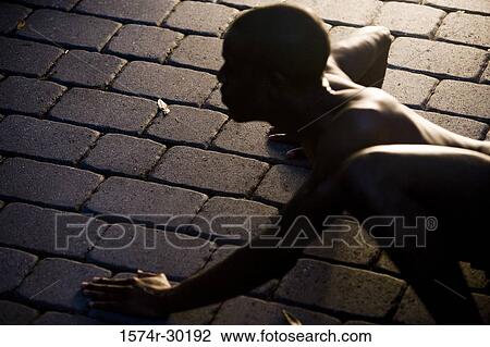 Young man crawling on tiled floor View Large Photo Image Stock Image - Young man crawling on tiled floor. Fotosearch