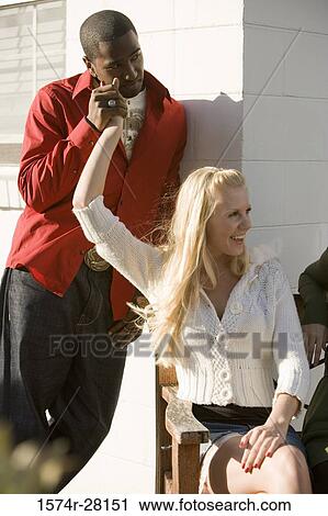 Young man holding hand of a mid adult woman View Large Photo Image Stock Image - Young man holding hand of a mid adult woman. Fotosearch