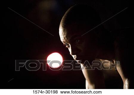Young man looking away with the moon in the background View Large Photo Image Stock Photo - Young man looking away with the moon in the background. Fotosearch
