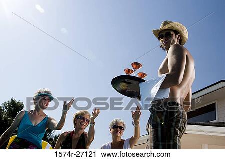 Young man serving drinks to senior women View Large Photo Image Stock Image - Young man serving drinks to senior women. Fotosearch