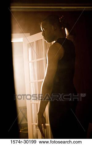 Young man standing at the doorway View Large Photo Image Stock Photo - Young man standing at the doorway. Fotosearch