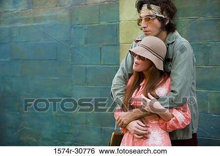 Stock Photograph - Young man standing with her sister. Fotosearch