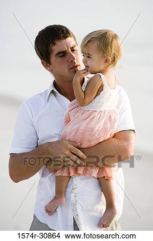 Picture - Young man with his daughter on the beach. Fotosearch