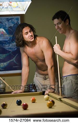 Young men playing pool with pool cue and ball on pool table View Large Photo Image Picture - Young men playing pool with pool cue and ball on pool table. Fotosearch