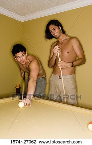 Young men playing pool with pool cue and ball on pool table View Large Photo Image Stock Image - Young men playing pool with pool cue and ball on pool table. Fotosearch
