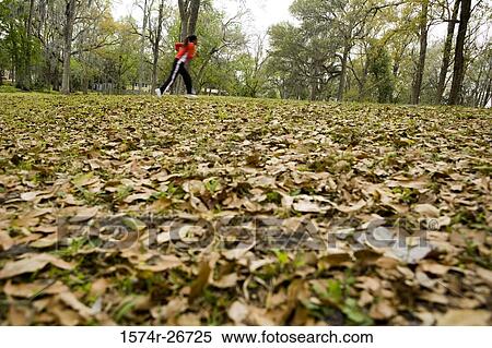 Young woman in sports clothing jogging on ground View Large Photo Image Stock Photography - Young woman in sports clothing jogging on ground. Fotosearch
