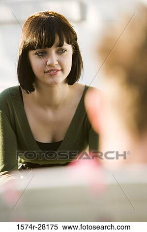 Stock Photography - Young woman looking away and smiling. Fotosearch