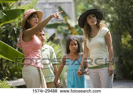 Young woman pointing while other looking up View Large Photo Image Stock Photo - Young woman pointing while other looking up. Fotosearch