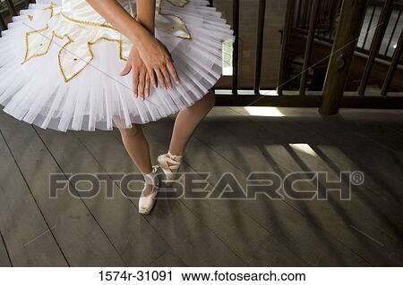 Stock Image - Young woman practicing ballet dancing. Fotosearch