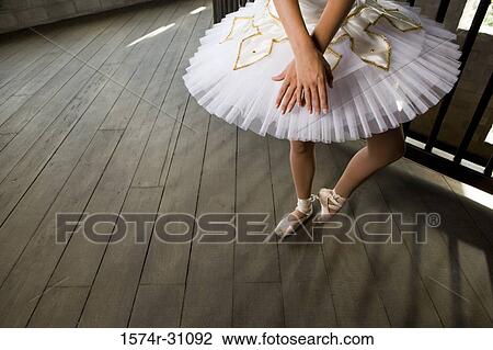Stock Image - Young woman practicing ballet dancing. Fotosearch