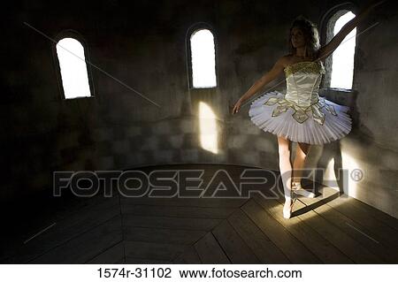 Stock Image - Young woman practicing ballet dancing. Fotosearch