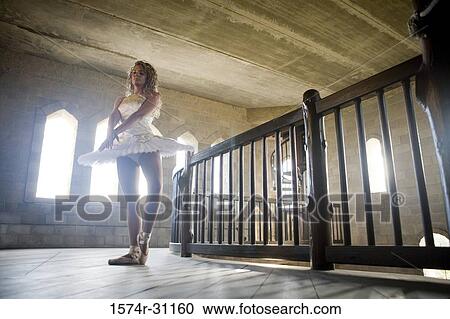 Stock Image - Young woman practicing ballet dancing. Fotosearch