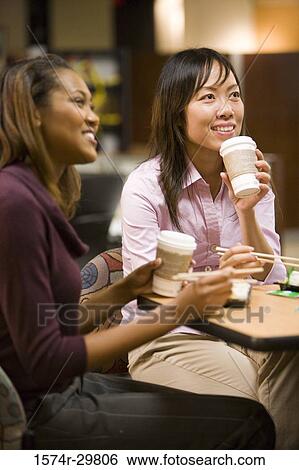 Young woman sitting and eating food View Large Photo Image Stock Photograph - Young woman sitting and eating food. Fotosearch