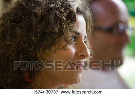 Young woman smiling and looking away View Large Photo Image Stock Photo - Young woman smiling and looking away. Fotosearch