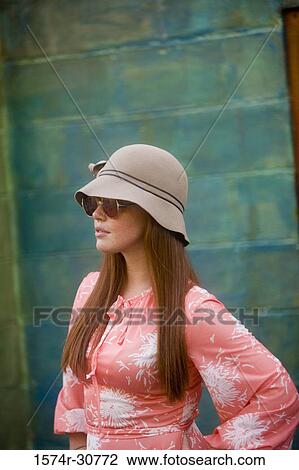 Young woman stand with her hand on hip View Large Photo Image Stock Image - Young woman stand with her hand on hip. Fotosearch