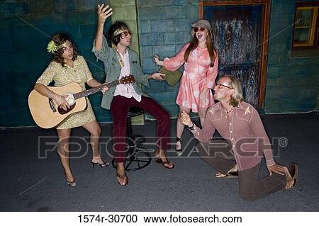 Young woman with a guitar while others beside View Large Photo Image Stock Image - Young woman with a guitar while others beside. Fotosearch