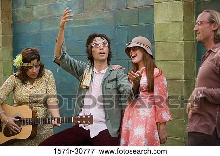 Young woman with a guitar while others beside View Large Photo Image Stock Photo - Young woman with a guitar while others beside. Fotosearch