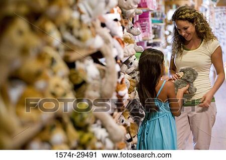 Young woman with daughter standing in store View Large Photo Image Stock Image - Young woman with daughter standing in store. Fotosearch