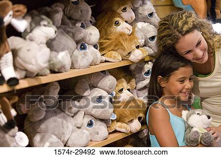Young woman with daughter standing in store View Large Photo Image Stock Image - Young woman with daughter standing in store. Fotosearch