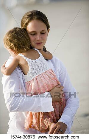 Young woman with her daughter on the beach View Large Photo Image Stock Photograph - Young woman with her daughter on the beach. Fotosearch