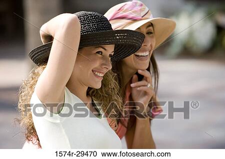Young women sitting together and smiling View Large Photo Image Stock Image - Young women sitting together and smiling. Fotosearch