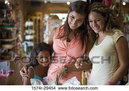 Young women with girl in store View Large Photo Image Picture - Young women with girl in store. Fotosearch