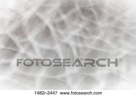 Stock Photo - Abstract motion blur looking down on a stone patio with snow. Fotosearch