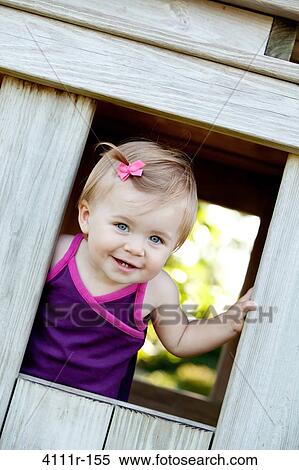 Baby girl peeking from a window of a cabin, Traverse City, Grand Traverse County, Michigan, USA View Large Photo Image Stock Photography - Baby girl peeking from a window of a cabin, Traverse City, Grand Traverse County, Michigan, USA. Fotosearch