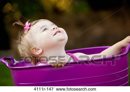 Baby girl playing in a bathtub and smiling, Traverse City, Grand Traverse County, Michigan, USA View Large Photo Image Stock Photo - Baby girl playing in a bathtub and smiling, Traverse City, Grand Traverse County, Michigan, USA. Fotosearch