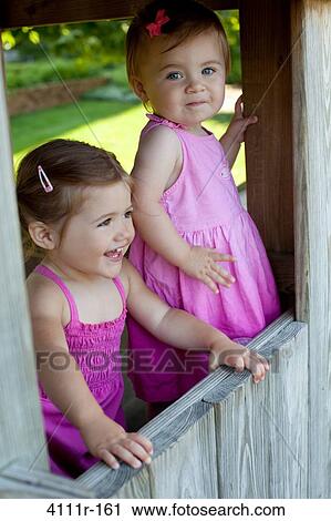 Baby girls in a cabin, Traverse City, Grand Traverse County, Michigan, USA View Large Photo Image Stock Image - Baby girls in a cabin, Traverse City, Grand Traverse County, Michigan, USA. Fotosearch