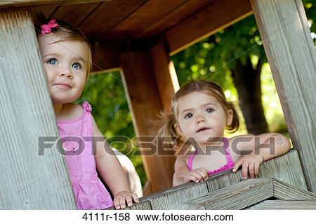 Baby girls in a cabin, Traverse City, Grand Traverse County, Michigan, USA View Large Photo Image Stock Photo - Baby girls in a cabin, Traverse City, Grand Traverse County, Michigan, USA. Fotosearch