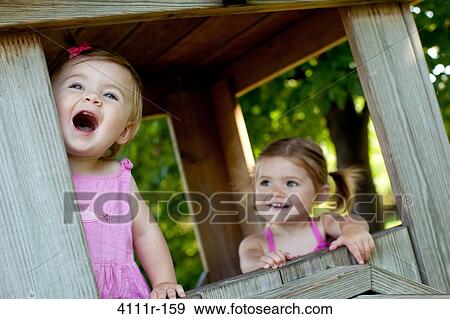 Baby girls in a cabin, Traverse City, Grand Traverse County, Michigan, USA View Large Photo Image Stock Photo - Baby girls in a cabin, Traverse City, Grand Traverse County, Michigan, USA. Fotosearch