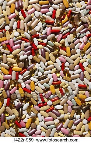 Stock Photo - Background of colorful multi-vitamin pills, tablets and capsules. Fotosearch