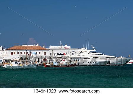 Boats docked at a harbor, Mykonos Town, Mykonos, Cyclades Islands, Greece View Large Photo Image Stock Image - Boats docked at a harbor, Mykonos Town, Mykonos, Cyclades Islands, Greece. Fotosearch