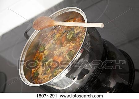 Stock Image - Boiling casserole of soup on a stove. Fotosearch