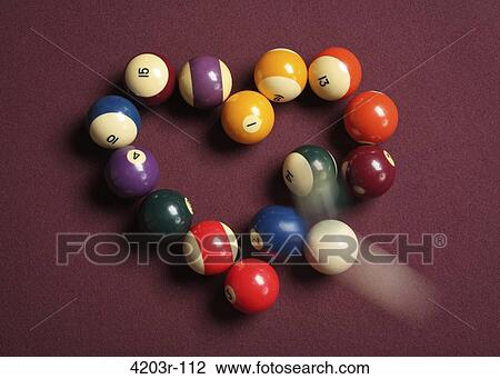 Stock Image - Break-up concept of cue ball breaking heart-shaped billiard balls. Fotosearch
