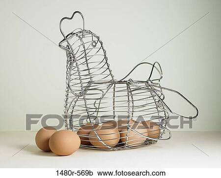 Brown eggs in a hen shaped wire basket View Large Photo Image Stock Image - Brown eggs in a hen shaped wire basket. Fotosearch